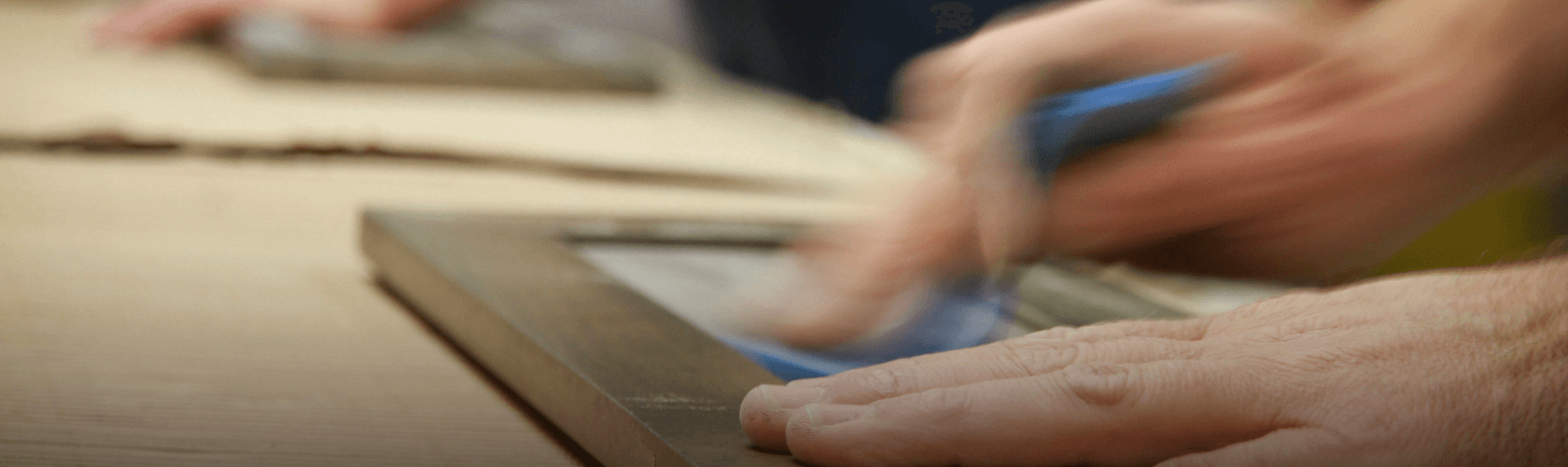 Photo of someone sanding a door